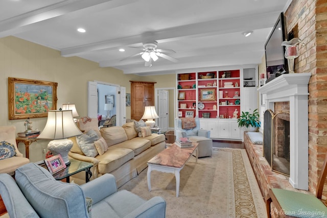 living area featuring built in features, a ceiling fan, light wood-type flooring, a fireplace, and beam ceiling