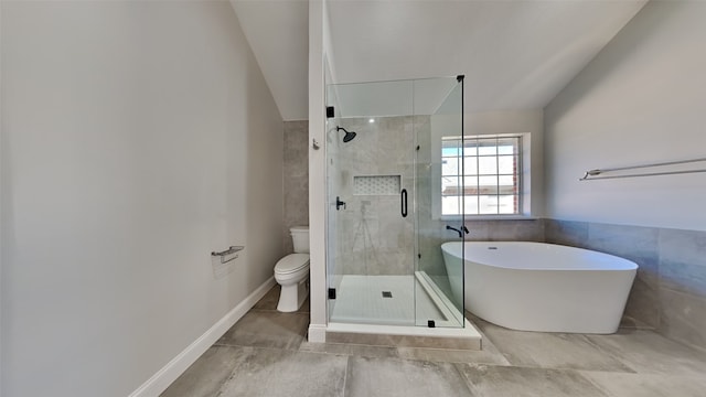 full bathroom with tile walls, a soaking tub, toilet, a stall shower, and vaulted ceiling