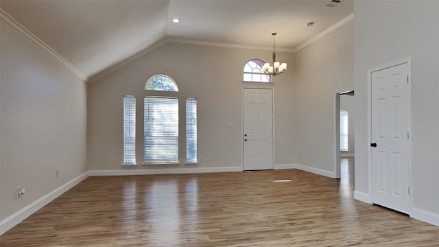 foyer featuring a chandelier, ornamental molding, light wood-type flooring, and baseboards