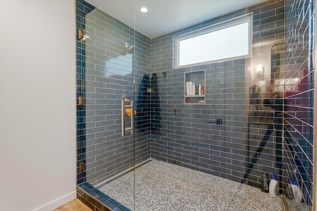 full bathroom with a stall shower and baseboards