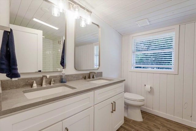 full bathroom featuring wooden ceiling, a sink, and toilet