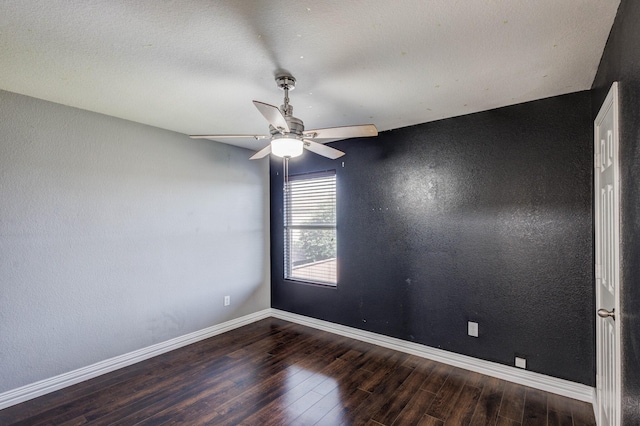 unfurnished room with a ceiling fan, baseboards, wood finished floors, and a textured wall