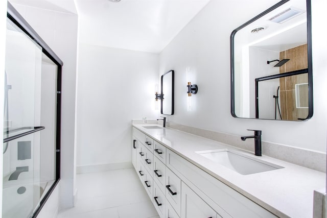 bathroom featuring enclosed tub / shower combo, double vanity, a sink, and visible vents