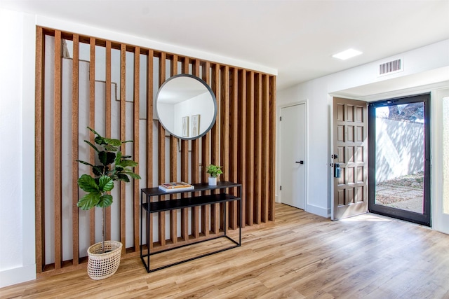 foyer entrance with light wood-type flooring and visible vents