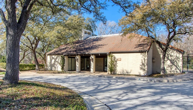 view of front of property featuring a tile roof and stucco siding