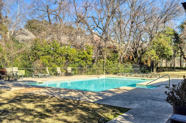 pool with fence and a patio