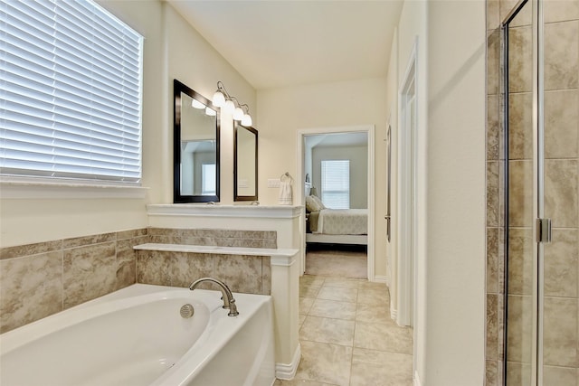 ensuite bathroom featuring ensuite bathroom, a garden tub, and tile patterned floors