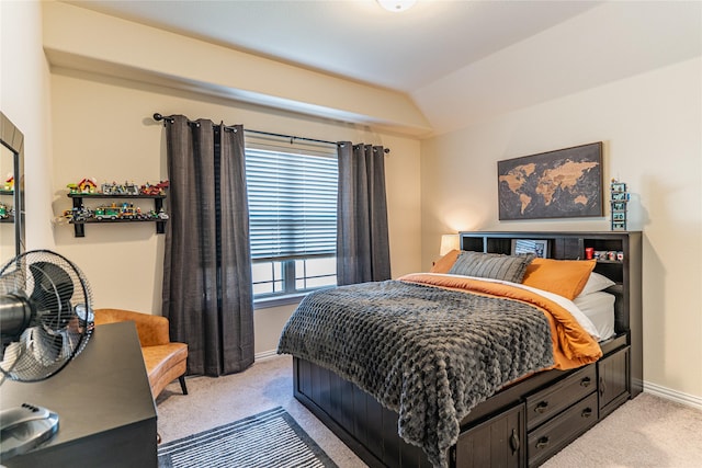 bedroom with light carpet, vaulted ceiling, and baseboards