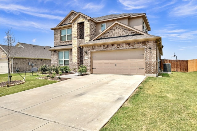 view of front of house featuring an attached garage, fence, a front yard, central AC, and brick siding