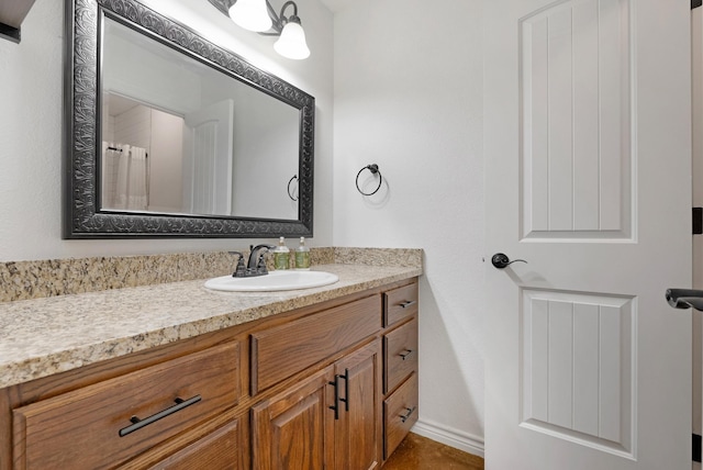 bathroom featuring vanity and baseboards