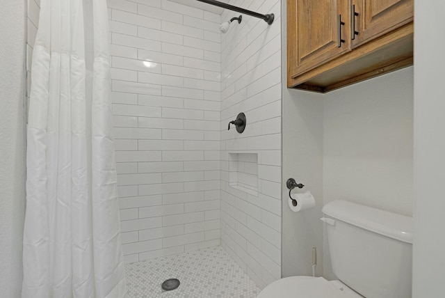 bathroom with a stall shower and toilet