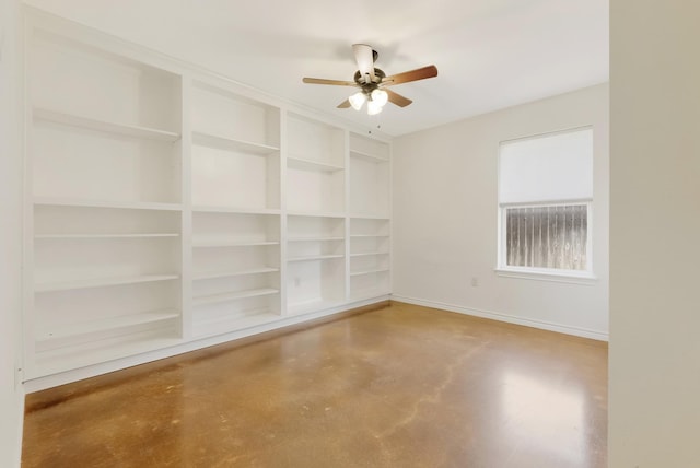 spare room with concrete flooring, ceiling fan, and baseboards