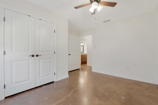 unfurnished bedroom featuring a closet, visible vents, finished concrete floors, a ceiling fan, and baseboards