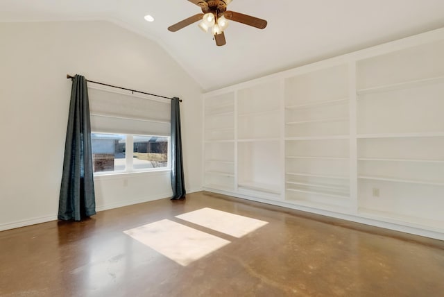 empty room with a ceiling fan, lofted ceiling, concrete floors, and built in shelves