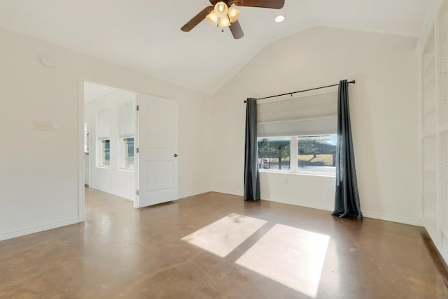 spare room with lofted ceiling, ceiling fan, baseboards, and concrete flooring