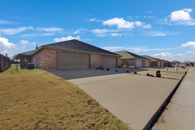 ranch-style house featuring a garage, concrete driveway, fence, central AC, and brick siding