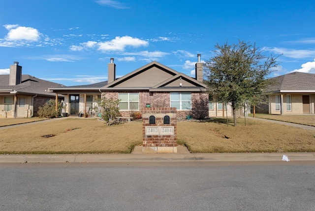 view of front of property with brick siding and a chimney