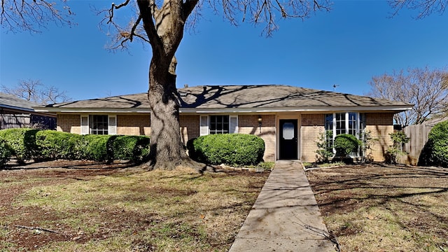 ranch-style home with brick siding and fence