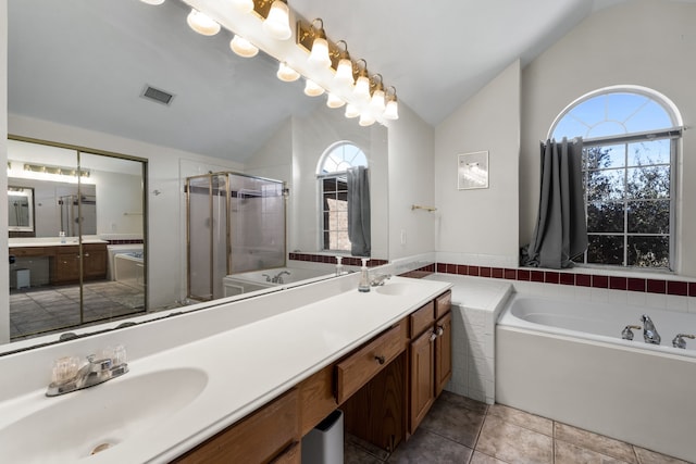 full bathroom with double vanity, lofted ceiling, visible vents, a sink, and a shower stall