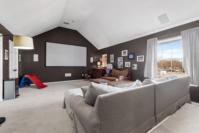 carpeted home theater featuring lofted ceiling, baseboards, and visible vents