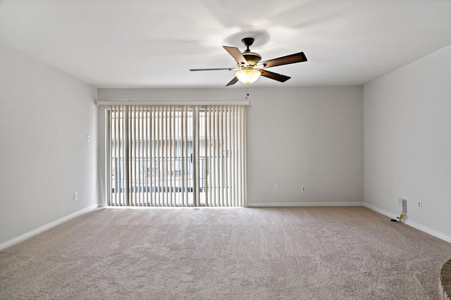 empty room featuring carpet, baseboards, and ceiling fan