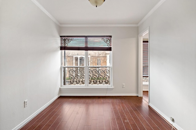 empty room featuring baseboards, ornamental molding, and dark wood-style flooring