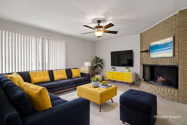 living area with a brick fireplace, a ceiling fan, and light carpet