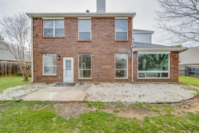 back of house featuring a patio, brick siding, and fence