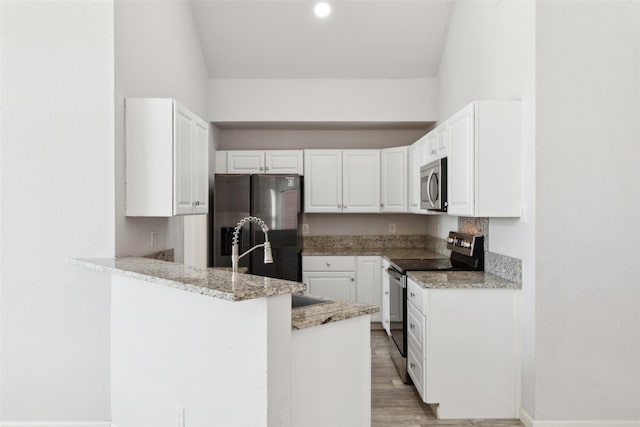 kitchen featuring light wood-style floors, appliances with stainless steel finishes, a peninsula, white cabinets, and light stone countertops