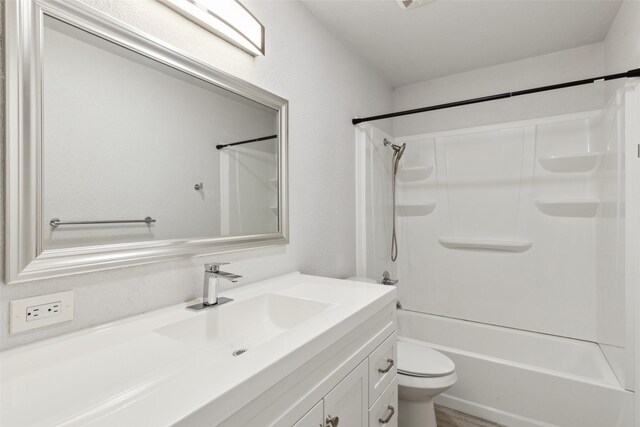 full bathroom featuring toilet, vanity, and bathtub / shower combination