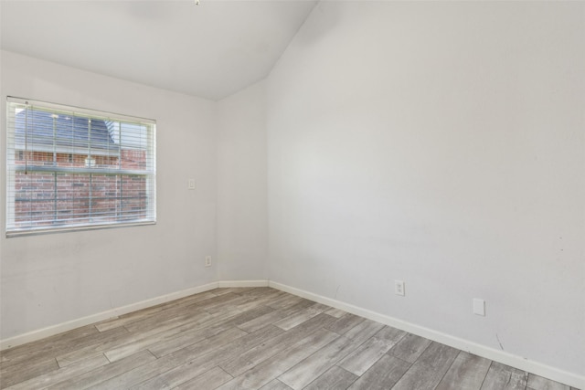 unfurnished room with light wood-type flooring and baseboards