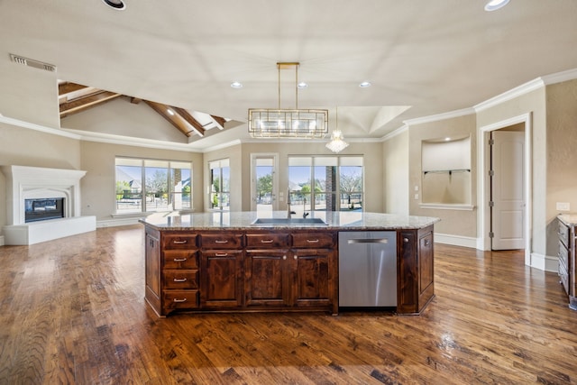 kitchen featuring stainless steel dishwasher, a glass covered fireplace, visible vents, and dark wood-type flooring