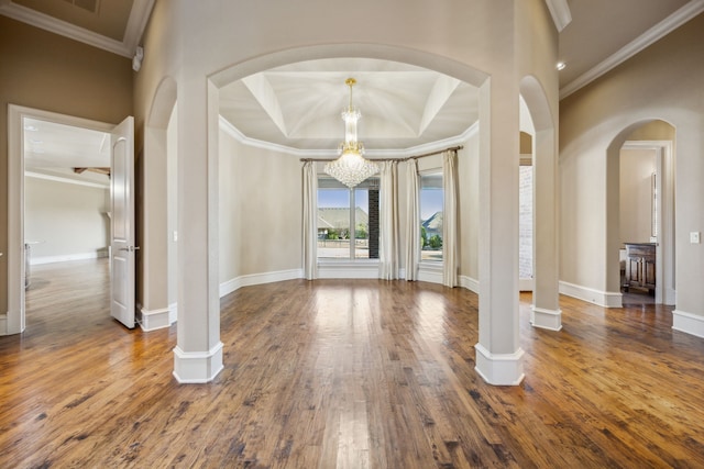 entryway featuring baseboards, an inviting chandelier, hardwood / wood-style floors, and crown molding