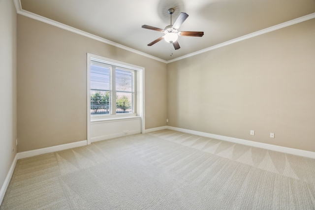 empty room with baseboards, light colored carpet, and ornamental molding