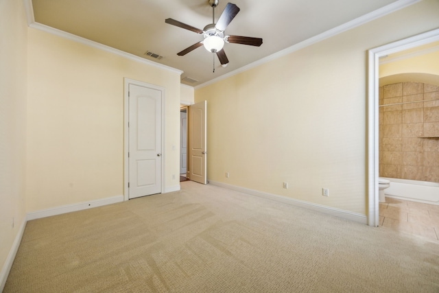 unfurnished bedroom featuring visible vents, ornamental molding, ensuite bathroom, carpet, and baseboards