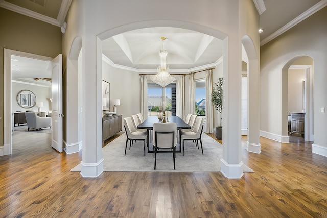 2161 Meadow View Dr, Prosper, TX 75078 - dining room featuring arched walkways, a chandelier, wood finished floors, and crown molding