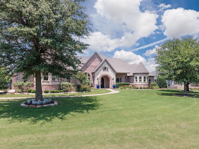 2161 Meadow View Dr, Prosper, TX 75078 - french country home featuring a front lawn, brick siding, and stone siding