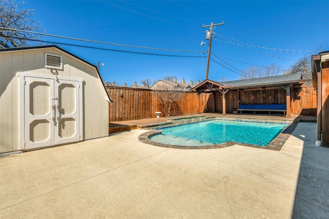 view of swimming pool featuring a patio, a fenced backyard, an outdoor structure, a fenced in pool, and a shed