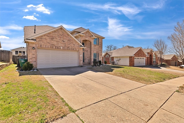 traditional-style home with a garage, brick siding, fence, driveway, and a front yard