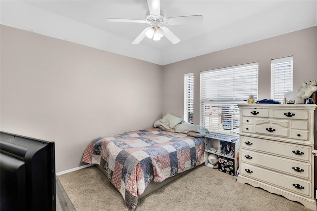 bedroom with vaulted ceiling, baseboards, a ceiling fan, and light colored carpet