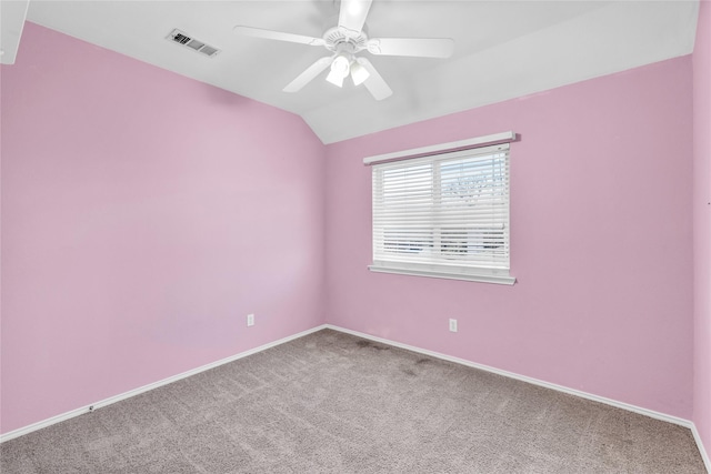 unfurnished room with carpet floors, visible vents, a ceiling fan, vaulted ceiling, and baseboards