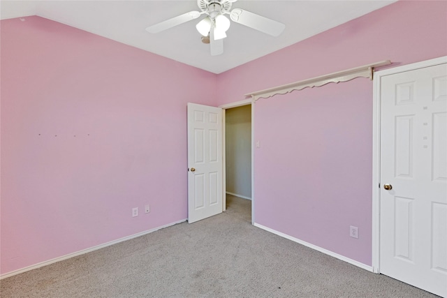 unfurnished bedroom featuring carpet, vaulted ceiling, ceiling fan, and baseboards