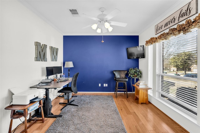 office with visible vents, crown molding, baseboards, and wood finished floors