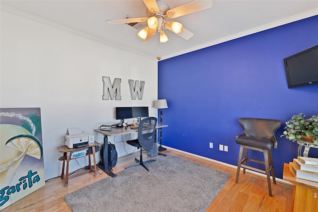 office featuring a ceiling fan, crown molding, and wood finished floors