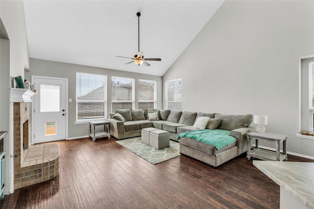 living area featuring dark wood-style floors, a fireplace, high vaulted ceiling, and baseboards