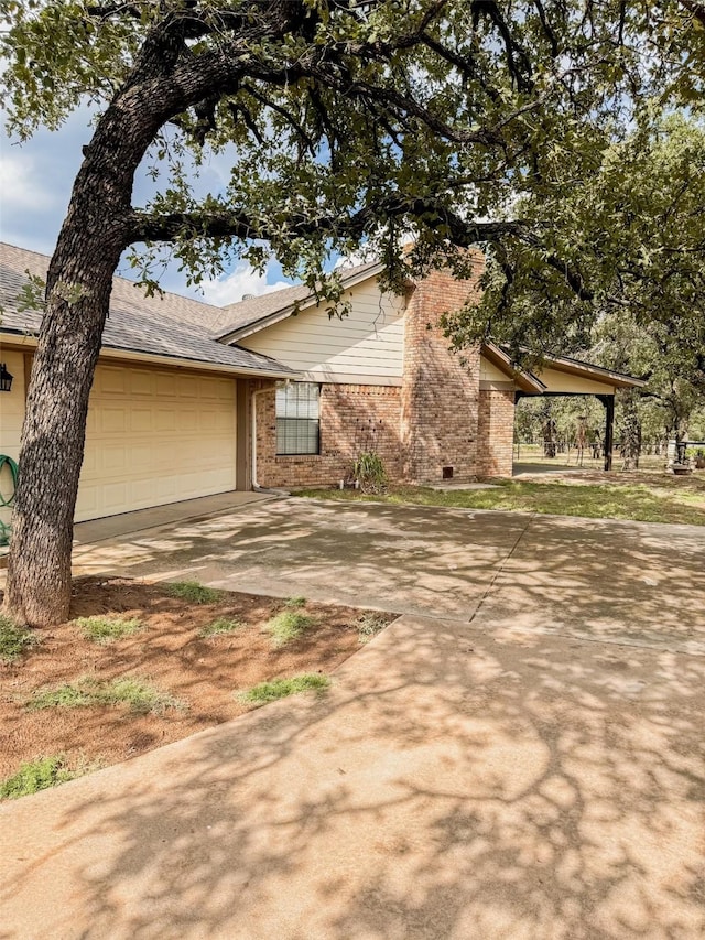 view of front of house with a garage, driveway, and brick siding