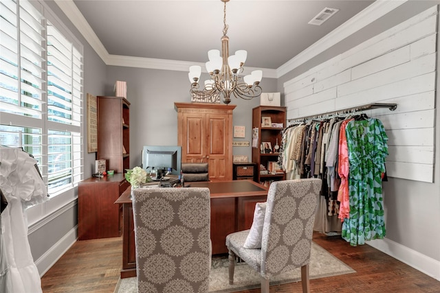 dining room featuring crown molding, visible vents, a chandelier, and wood finished floors