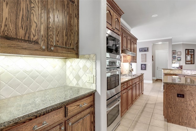 kitchen featuring stainless steel appliances, stone countertops, crown molding, and light tile patterned floors