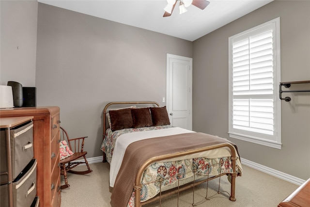 carpeted bedroom with ceiling fan and baseboards