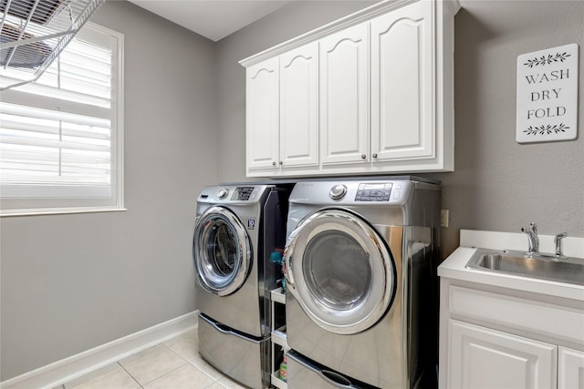 2104 Germantown, Mckinney, TX 75070 - laundry room featuring washing machine and dryer, cabinet space, a sink, baseboards, and light tile patterned flooring